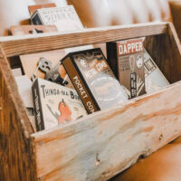 Shop Small Business Rise & Wander Company in St George Utah | My Local Utah A display of handcrafted wood decor with adventure gear and apparel from rise & wander company including backpacks books and some other and hiking essentials My local utah